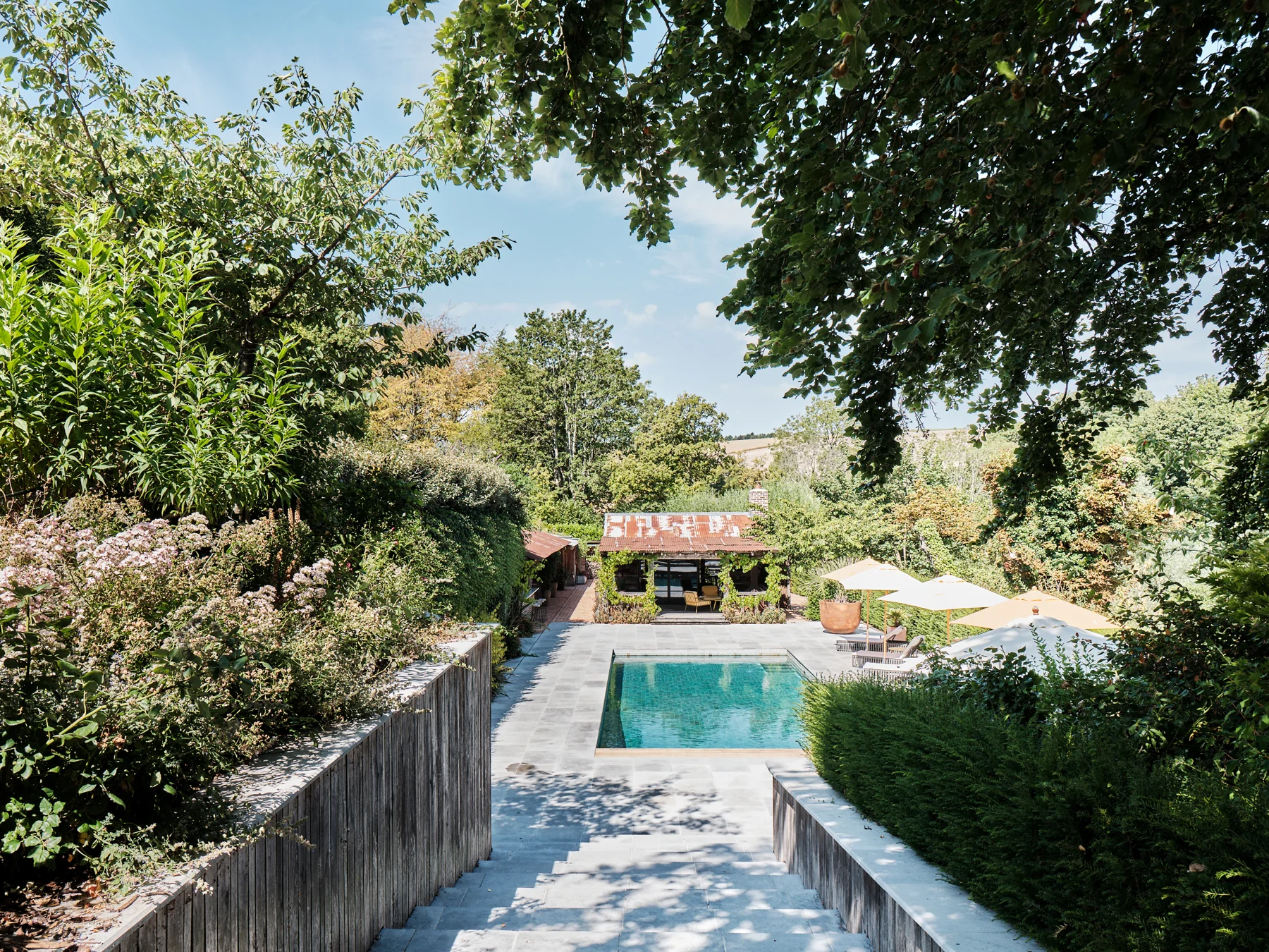 Garden steps leading to the pool and pavilion at A Garden Retreat